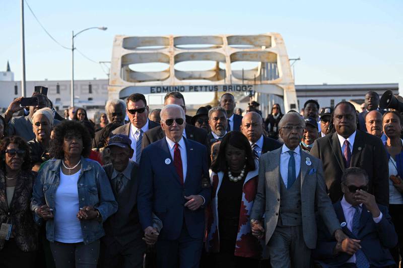 US President Joe Biden leads a party across Edmund Pettus Bridge in Selma, Alabama, to mark the 58th anniversary of Bloody Sunday, when more than 600 civil rights demonstrators were beaten by white police officers. AFP