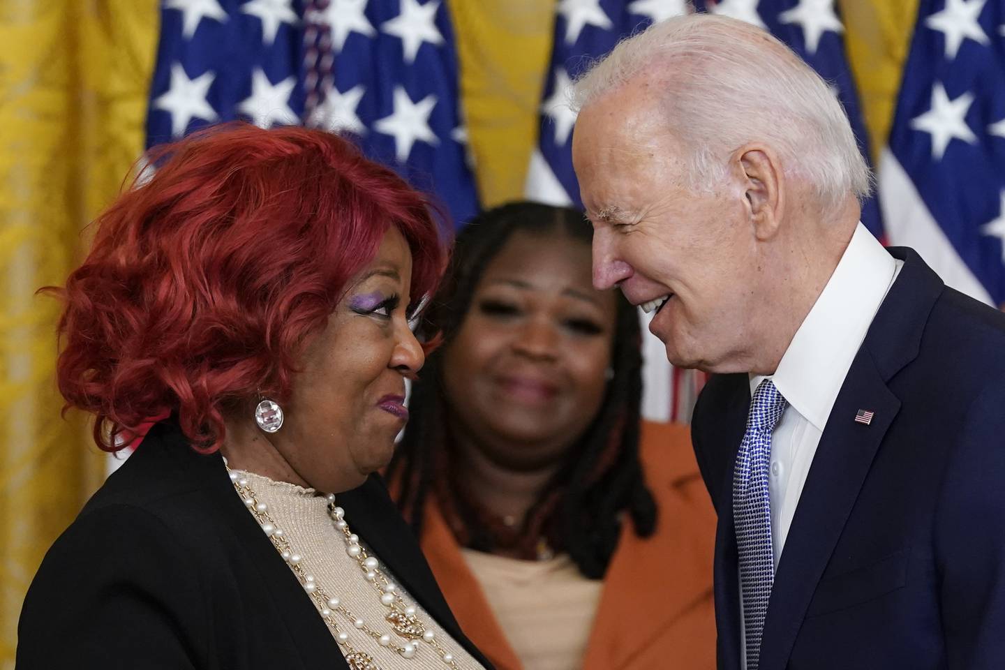 Former Georgia poll worker, Shaye Moss, centre, looks on as President Joe Biden awards the Presidential Citizens Medal to her mother Ruby Freeman during a ceremony at the White House. AP