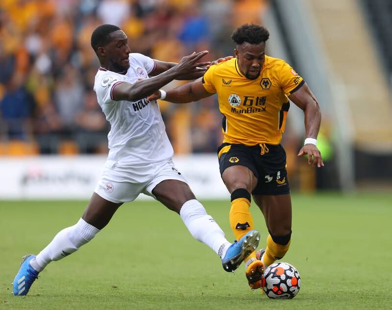 WOLVERHAMPTON, ENGLAND - SEPTEMBER 18: Adama Traore of Wolverhampton Wanderers is challenged by Shandon Baptiste of Brentford during the Premier League match between Wolverhampton Wanderers and Brentford at Molineux on September 18, 2021 in Wolverhampton, England. (Photo by Catherine Ivill / Getty Images)
