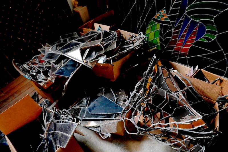 What remains of a church's stained-glass windows after Beirut's massive August 4 explosion lie in cardboard boxes in Lebanese artist Maya Husseini's basement workshop on the outskirts of the Lebanese capital, on September 18, 2020. Husseini had hoped to retire after decades of designing colourful windows, but now she is overwhelmed with requests after a massive explosion ripped through Beirut on August 4. 
She is one of several artists slowly starting to restore the artworks devastated in disaster.  / AFP / ANWAR AMRO
