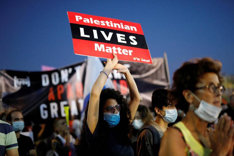 People wearing face masks protest against Israeli Prime Minister Benjamin Netanyahu's plan to annex parts of the Israeli-occupied West Bank, in Tel Aviv, Israel, on June 6, 2020. Reuters