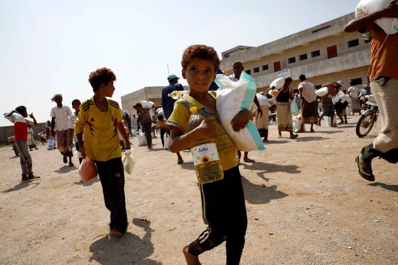 Displaced Yemenis get emergency food aid provided by a local relief group, Mona Relief Yemen in the western province of Hajjah, Yemen. EPA