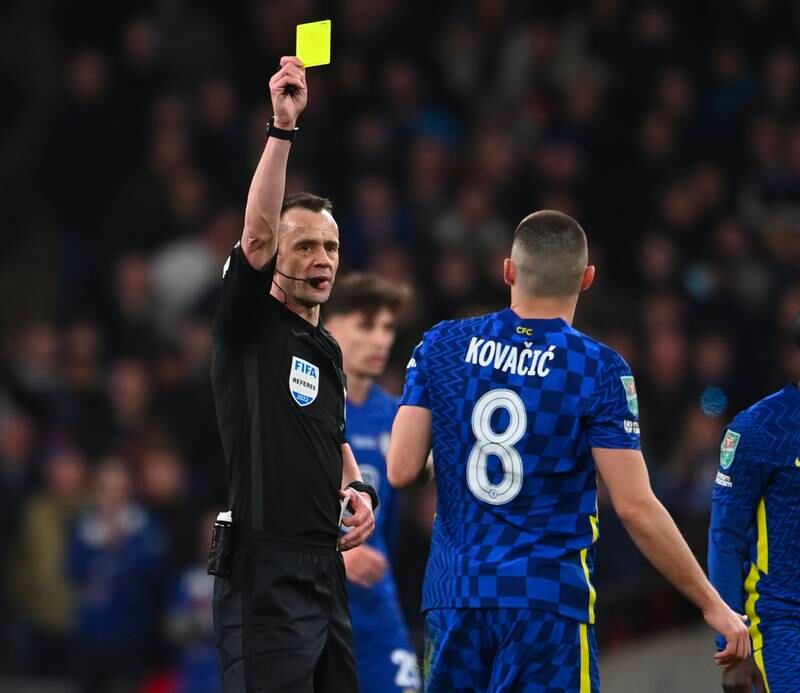 Referee Stuart Attwell shows the yellow card to Mateo Kovacic of Chelsea on Sunday. EPA