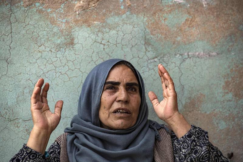 Displaced from the border town of Ras Al Ain, Syrian Kurdish mother Shara Sido, 65, who's son was allegedly shot dead by Turkey-backed Syrian fighters, sits inside a house in the de-facto Syrian Kurdish capital of Qamishli. AFP