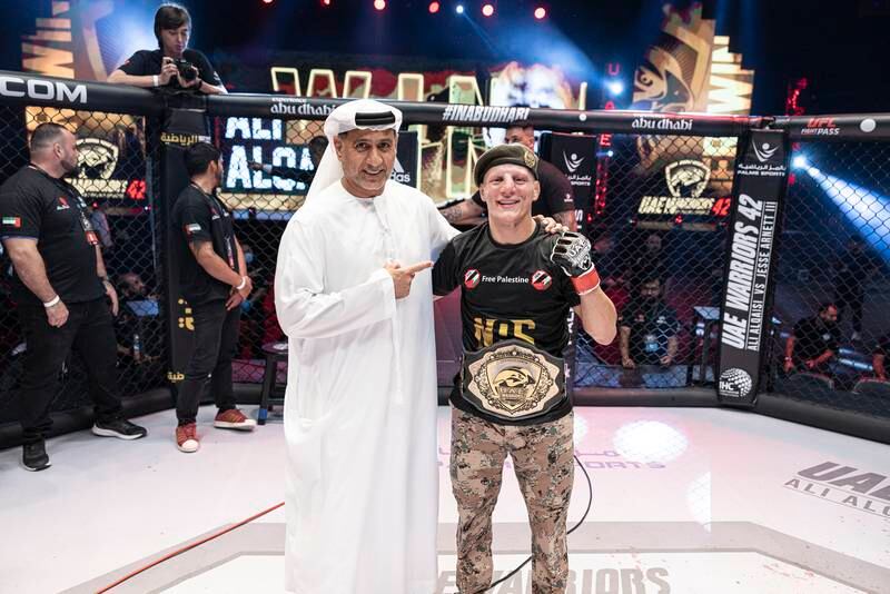 Ali Al Qaisi is congratulated by Abdulmunam Al Hashemi, chairman of Palms Sports, after he beat Jesse Arnett at the Etihad Arena to retain his UAE Warriors featherweight belt on May 20, 2023. All photos: UAE Warriors