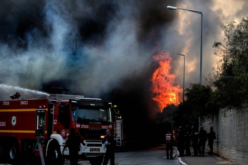 Firefighters deploy after a factory hit by a rocket caught fire in Sderot, southern Israel, Israel. AP Photo