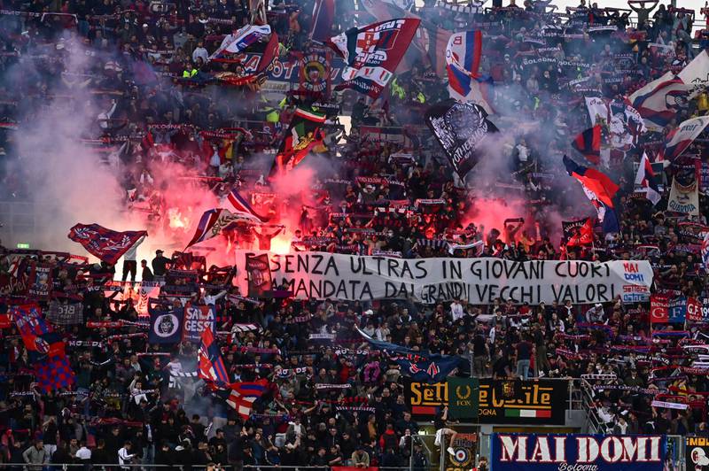 Bologna supporters cheer, wave flags and set off flares during the Serie A match against Inter Milan. AFP