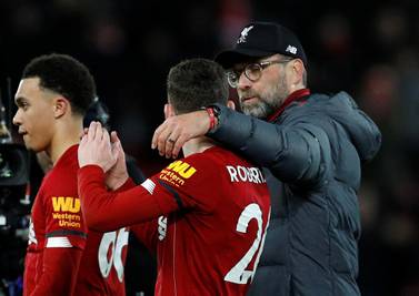 Liverpool manager Jurgen Klopp celebrates with Andrew Robertson and Trent Alexander-Arnold after the West Ham match. Reuters