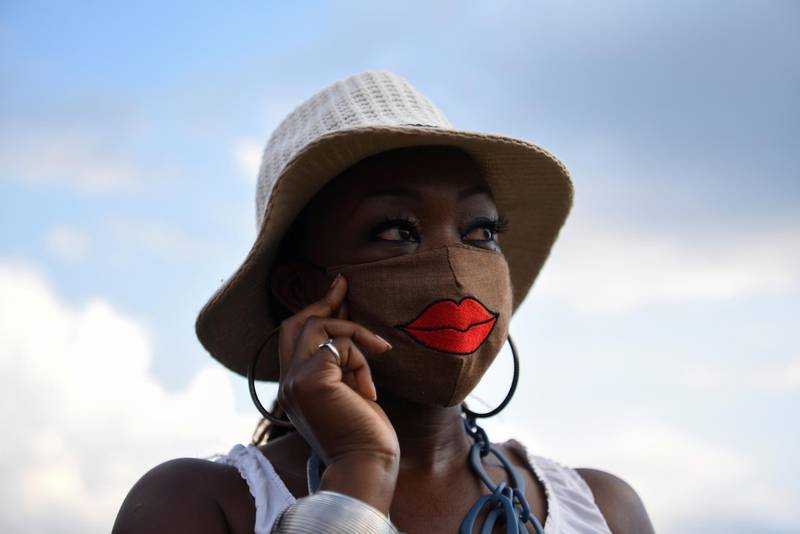 A woman wears a mask as hundreds attend a vigil for George Floyd, whose death in Minneapolis police custody has sparked nationwide protests against racial inequality, at Jack Yates High School in Houston.. Reuters