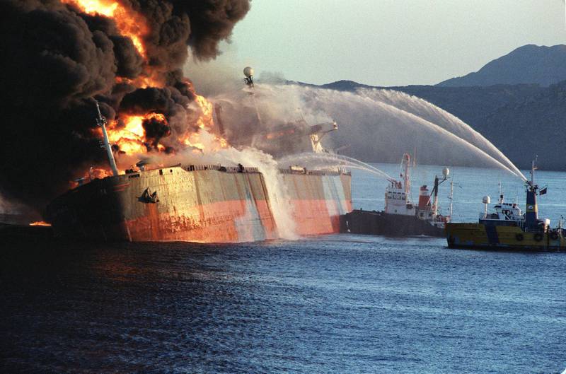 The Singapore flagged 85-thousand ton Norman Atlantic stands ablaze 06 December 1987 after she was attacked by an Iranian warship in Omani territorial waters as it approached the Strait of Hormuz.  The Iranians attacked 2 tankers in the region killing one aboard the Danish tanker Estelle Maersk and setting the Singapore tanker Norman Atlantic ablaze.  The Tanker War started properly in 1984 when Iraq attacked Iranian tankers and the vital oil terminal at Kharg island. Iran struck back by attacking tankers carrying Iraqi oil from Kuwait and then any tanker of the Gulf states supporting Iraq. The air and small boat attacks did very little to damage the economies of either country and the price of oil was never seriously affected as Iran just moved it's shipping port to Larak Island in the straights of Hormuz.  AFP PHOTO NORBERT SCHILLER (Photo by NORBERT SCHILLER / AFP)