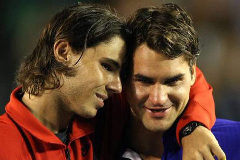 Rafael Nadal (L) of Spain embraces Roger Federer of Switzerland during the trophy presentation for the men's tennis final on day 14 of the Australian Open in Melbourne on early February 2, 2009.    Rafael Nadal won a classic Australian Open final against Roger Federer 7-5, 3-6, 7-6 (7/3), 3-6, 6-2 to secure his first hard-court Grand Slam and stop the Swiss equalling the all-time Majors record.          AFP PHOTO / GREG WOOD