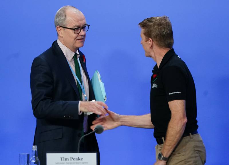 Sir Patrick Vallance, the British government's chief scientific adviser, shakes hands with astronaut Tim Peake ahead of their appearance at Cop26. PA