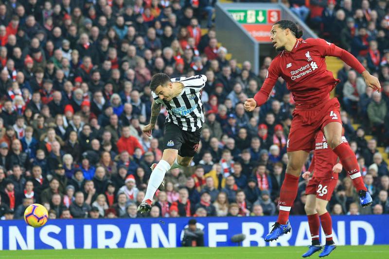 Newcastle's Joselu, left, and Liverpool's van Dijk jump for the ball. AP Photo