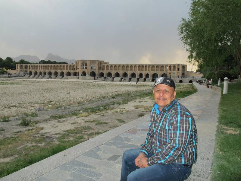 Hamid Khorshidi sits by the dry riverbed of the Zayandehrood in the ancient city of Isfahan in central Iran.