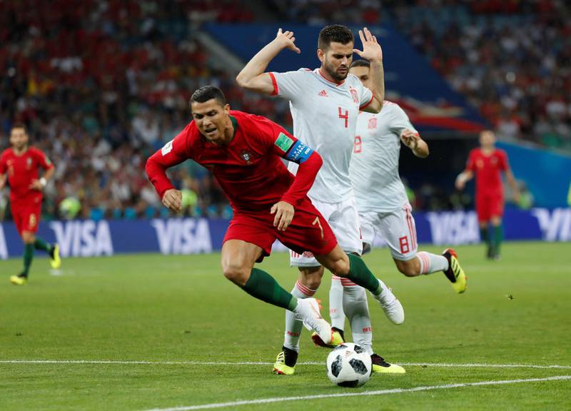 Spain's Nacho brings down Portugal's Cristiano Ronaldo to give away a penalty. Murad Sezer / Reuters