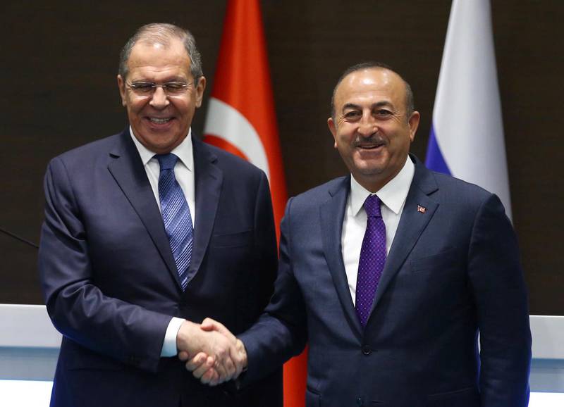 Turkey's Foreign Minister Mevlut Cavusoglu, right, and his Russian counterpart Sergei Lavrov shake hands after a news conference in the Mediterranean coastal city of Antalya, Turkey, Friday, March 29, 2019. Turkey's foreign minister said Friday his country is committed to a deal to purchase advanced Russian surface-to-air missile defense system, despite warnings from Washington that the deal could put the NATO member country's participation in the U.S. F-35 fighter aircraft program at risk. (Turkish Foreign Ministry via AP, Pool)