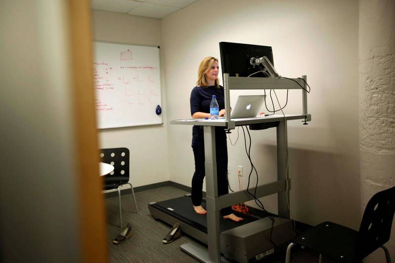 Julie Thompson, vice president of produce at Eventbrite, walks on a treadmill that doubles as a desk at the company's headquarters in the South of Market area in San Francisco, California May 25, 2012. More than ever, technology entrepreneurs, and their investors and employees, are choosing the urban charms of San Francisco over the sprawl of neighboring Silicon Valley. In the South of Market district, the nexus of the city's tech industry, rents are soaring and latte lines are lengthening - conjuring memories of the dot-com bubble of the late 1990s. Picture taken May 25. To match Feature SANFRANCISCO-SILICONVALLEY/GEEKS     REUTERS/Robert Galbraith (UNITED STATES - Tags: BUSINESS SCIENCE TECHNOLOGY)