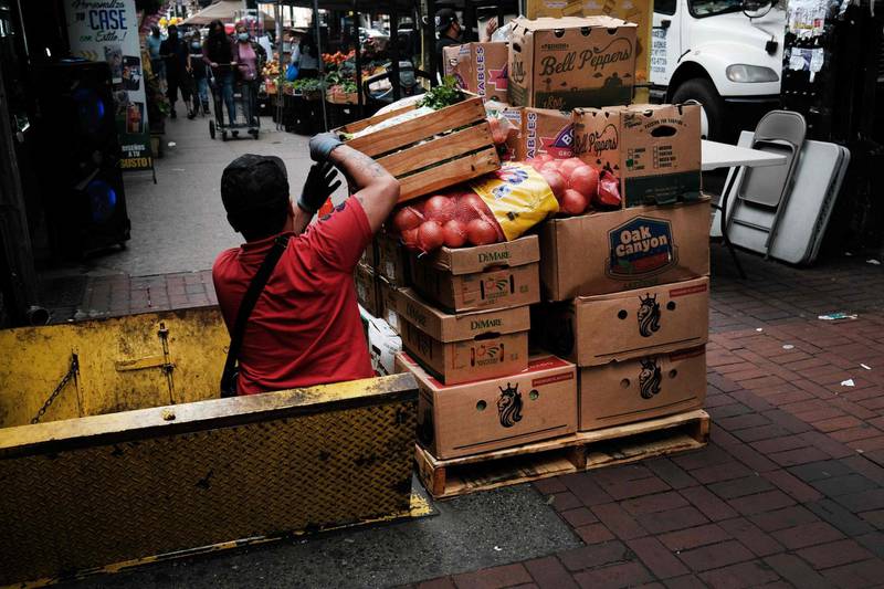 (FILES) In this file photo taken on June 4, 2021, a man moves food boxes at a restaurant in the Queens borough of New York City. The reopening US economy pushed weekly filings for jobless benefits to a new pandemic low for the sixth consecutive week, the Labor Department said on June 10, 2021, though at a slower rate than expected. / AFP / GETTY IMAGES NORTH AMERICA / SPENCER PLATT
