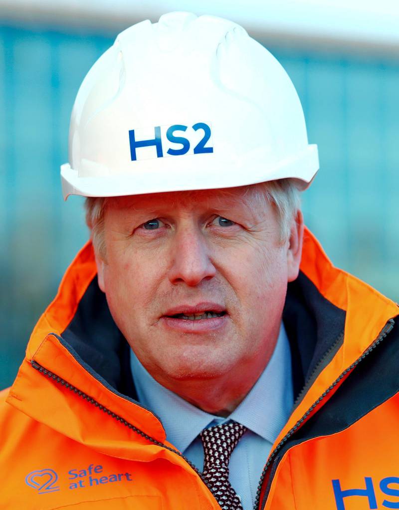Britain's Prime Minister Boris Johnson looks on during a visit to Curzon Street railway station where the new High Speed 2 (HS2) rail project is under construction, in Birmingham, England, Tuesday Feb. 11, 2020.  Boris Johnson said his Cabinet had given the â€œgreen lightâ€ to the high-speed rail line that will link London with central and northern England, despite the huge cost prediction and opposition from environmentalists. (Eddie Keogh/Pool via AP)