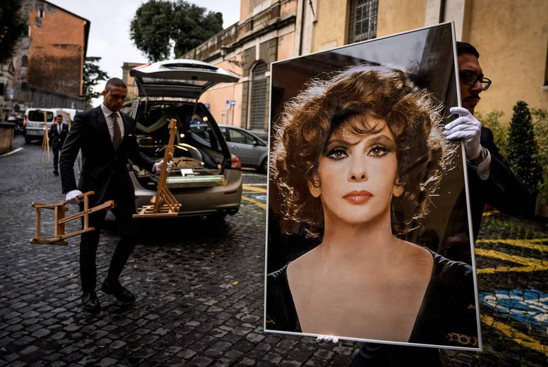 A man carries a photo of the late Italian actress Gina Lollobrigida for the installation of her lying in state, to allow the public to pay their respects, at Rome's Capitoline Hill. Lollobrigida, one of the last icons of the Golden Age of Hollywood, has died aged 95. AFP