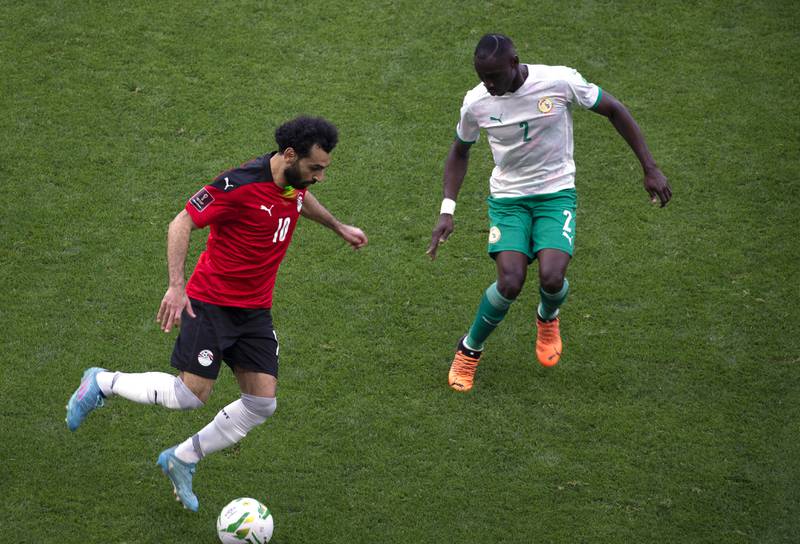 Egypt's Mohamed Salah under pressure from Saliou Ciss of Senegal. AP