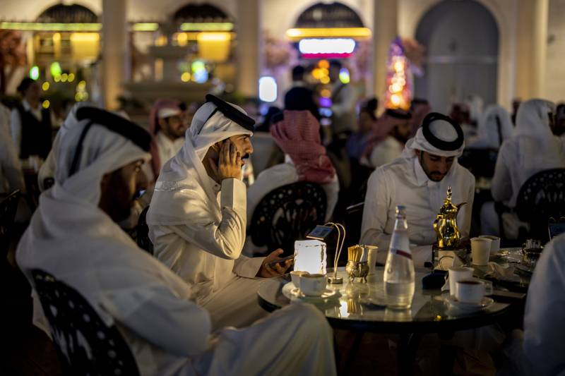 Customers relax on a restaurant terrace in Doha. AP