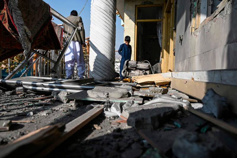 People inspect a damaged house after several rockets land at Khair Khana, north west of Kabul. A series of loud explosions shook central Kabul, including several rockets that landed near the heavily fortified Green Zone where many embassies and international firms are based, officials said. /AFP