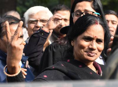 epa08079529 Mother (C) of a fatal gang rape victim of 2012 shows a victory sign at the Supreme Court in New Delhi, India, 18 December 2019. The Supreme Court on 18 December 2019 has rejected the plea to review death penalty of one of the four convicts, facing death sentence for the fatal gang rape of a 23-year-old student on a moving bus in 2012 which provoked widespread outrage and led to stricter laws against sexual assault.  EPA/STR