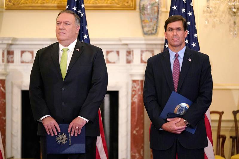 Secretary of State Mike Pompeo, left, and Defense Secretary Mark Esper attend a news conference to announce the Trump administration's restoration of sanctions on Iran, Monday, Sept. 21, 2020, at the U.S. State Department in Washington. (AP Photo/Patrick Semansky)