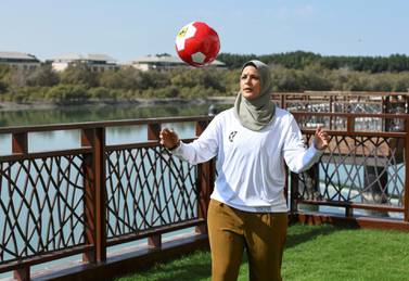Assmaah Helal practises her football skills in Abu Dhabi on Sunday. She took up the game at five, and in recent years has promoted social change through sport. Khushnum Bhandari for The National