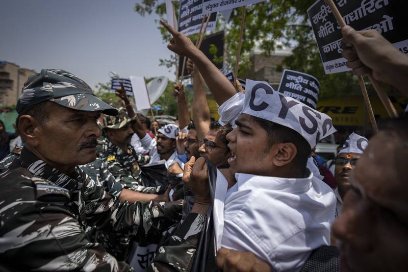 Indian paramilitary personnel try to stop students and activists in New Delhi. AP