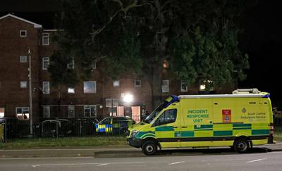 Emergency services seen near a block of flats off Basingstoke Road in Reading after an incident at Forbury Gardens park in the town centre of Reading. PA via AP