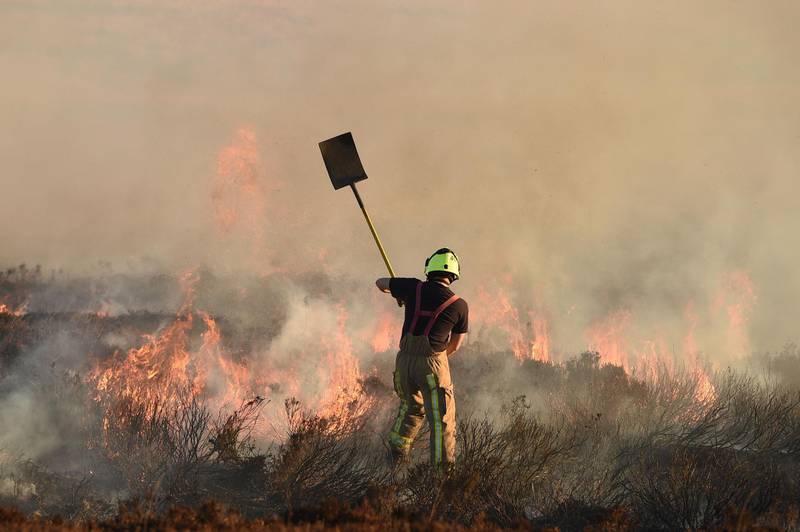 Firefighters tackle a blaze on moorland above Marsden. AFP