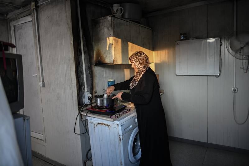 A Syrian woman cooks dinner in the camp. Getty Images