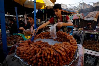 Yemeni confectioners sell a special sweet called Balah al-Sham at a market during Ramadan in the old city of Sanaa, Yemen. EPA