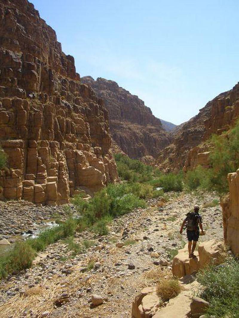 A hiker negotiates the stony path on the nine-hour trail from Feynan.