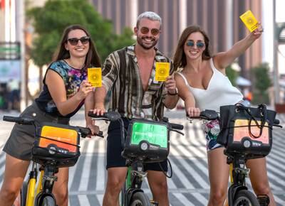 From left, Romanian Ionela Hapencu, Italian Antonio Bellomo and Julia Mularczyk from Poland pose with Expo passports on rented bikes.