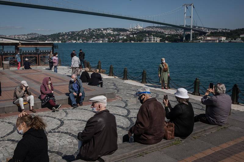Senior citizens, after having been on lockdown, are allowed to venture outdoors and enjoy the Bosphorus shoreline for a part of the first day of Eid in Istanbul, Turkey. Getty Images