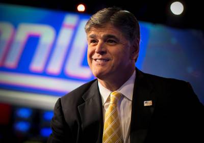 FILE PHOTO - Fox News Channel anchor Sean Hannity poses for photographs as he sits on the set of his show "Hannity" at the Fox News Channel's studios in New York City, October 28, 2014.  REUTERS/Mike Segar/File Photo