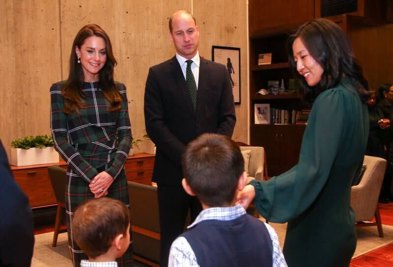 The Prince and Princess of Wales are greeted by Ms Wu and her sons at Boston City Hall. AP