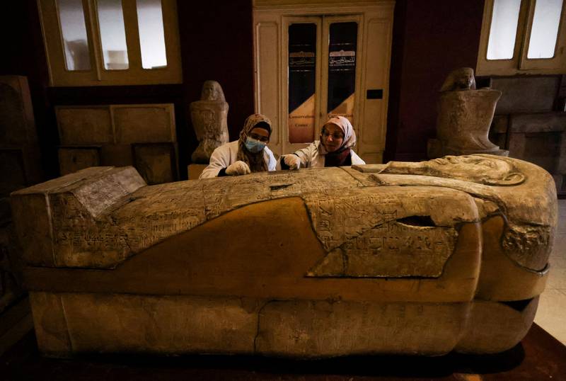 Archaeologists at the Egyptian Museum in Cairo examine a sarcophagus. Reuters