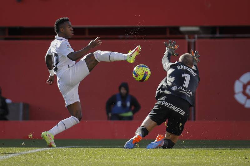 Mallorca goalkeeper Predrag Rajkovic attempts to block Real's Vinicius Junior. AP
