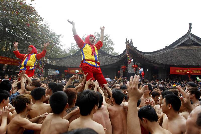 Villagers  perform a ritual during the traditional firecracker festival in Dong Ky, Bac Ninh province, Vietnam, on February 3, 2014. The festival which is held on the fourth day of the first lunar month every year, has attracted thousand of people. Luong Thai Linh / Reuters