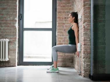 Wall squats can help to lower blood pressure – here's how to perform the exercise at home