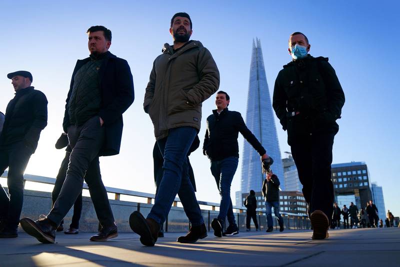 Commuters on London Bridge make their way into offices during the morning rush hour. PA