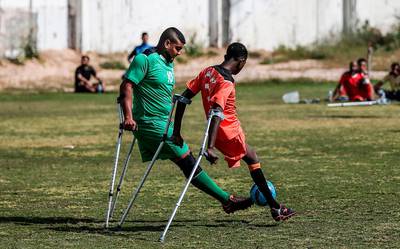 Palestinian amputees play in a football match overseen by Irish coach Simon Baker, general secretary of the European Amputee Football Federation, in Gaza City.  AFP