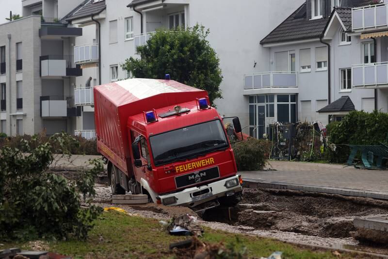 A fire department vehicle is stuck in a damaged street in Bad Neuenahr-Ahrweiler, Germany.