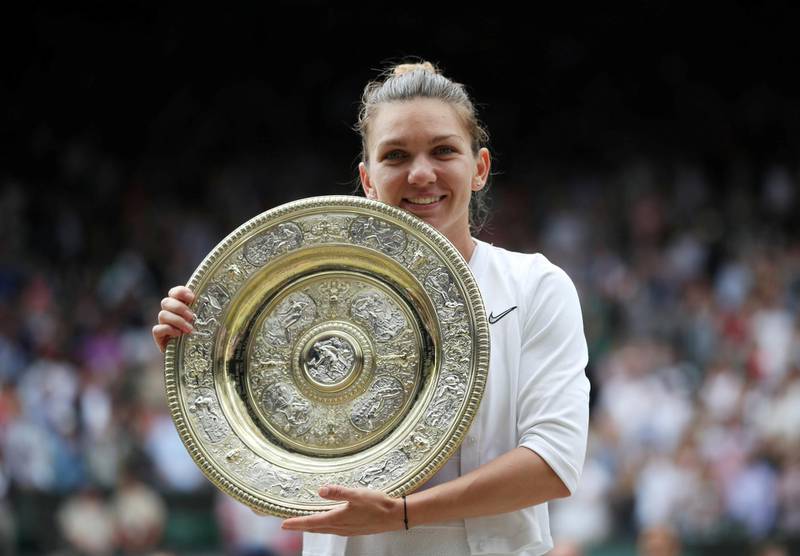 Simona Halep poses with the Venus Rosewater dish after beating Serena Williams in the Wimbleon final. Getty Images