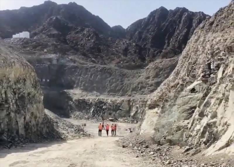 Crews are carving a path through the Hajar Mountains