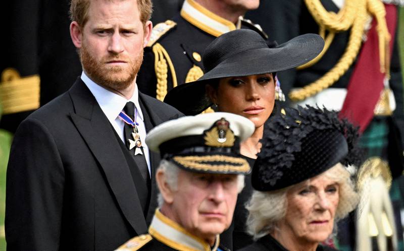 The Duke and Duchess of Sussex stand behind King Charles III and Queen Consort Camilla at Queen Elizabeth II's funeral in September. Reuters